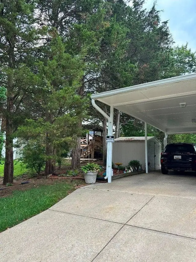 Aluminum carport installation with vehicle parked underneath