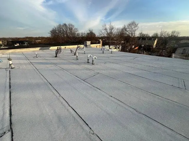EPDM flat roof membrane on a commercial building with pipe boot flashing
