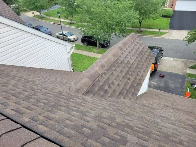 Completed architectural shingle roof with clean hip and ridge lines on a Laurel, MD home