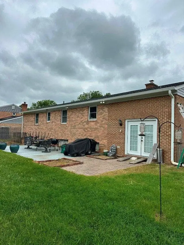 Seamless aluminum gutters installed on a brick rambler home
