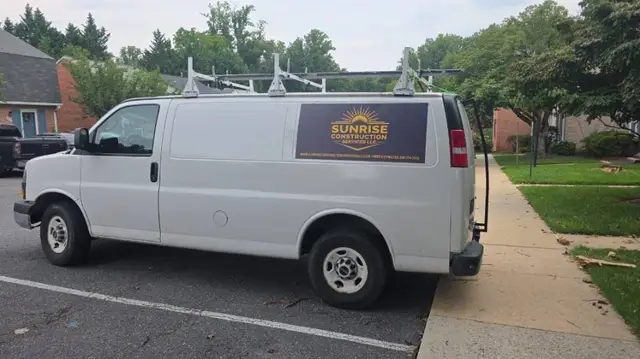 Sunrise Construction Services LLC branded work van with roof ladder rack in Laurel, MD