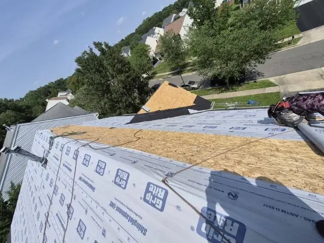 Synthetic underlayment rolled across new plywood roof decking on a Laurel, MD home